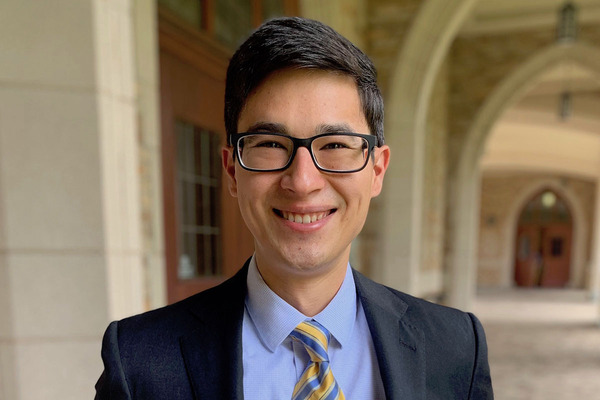 Nikolai Stieglitz, named the first recipient of the Exoneration Justice Clinic's postgraduate fellow, stands outside Notre Dame Law School and smiles to camera