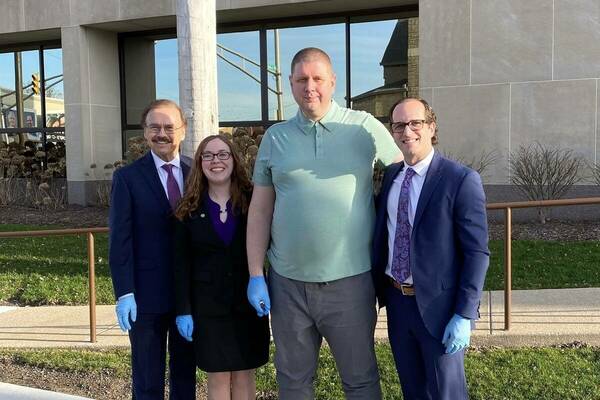 Jimmy Gurulé, Lenora Popken, Andrew Royer, and Elliot Slosar (left to right) stands outside the Exoneration Justice Clinic